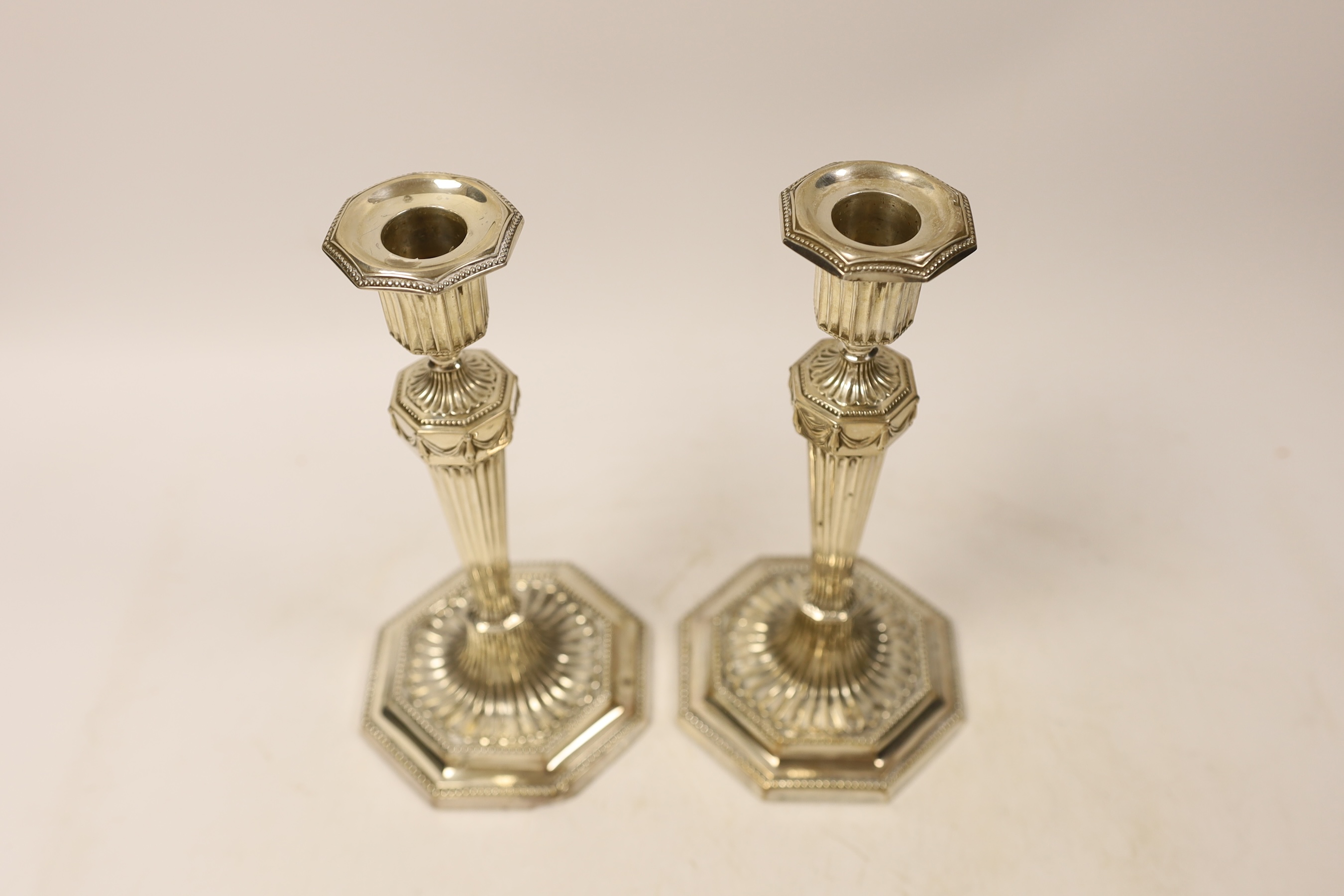 A pair of George V silver mounted candlesticks, on octagonal bases, Mappin & Webb, Sheffield, 1929, 20.9cm, weighted.
